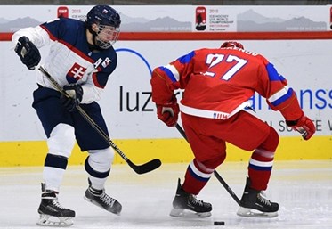LUCERNE, SWITZERLAND - APRIL 19: Slovakia's Boris Sadecky #8 gets the puck through the skates of Russia's Dmitri Zhukenov #27 during preliminary round action at the 2015 IIHF Ice Hockey U18 World Championship. (Photo by Matt Zambonin/HHOF-IIHF Images)

